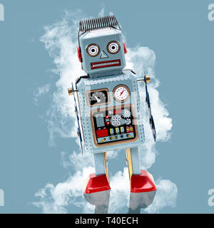 Retro Tin Robot on a blue background with smoke Stock Photo