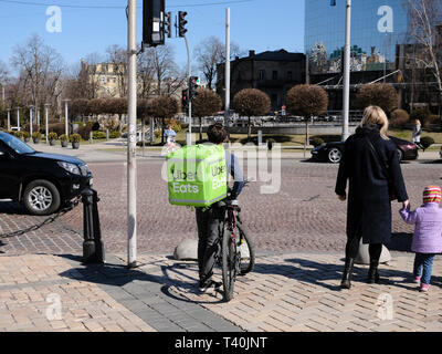 Uber Eats driver delivering food in the city of Kiev, Ukraine Stock Photo