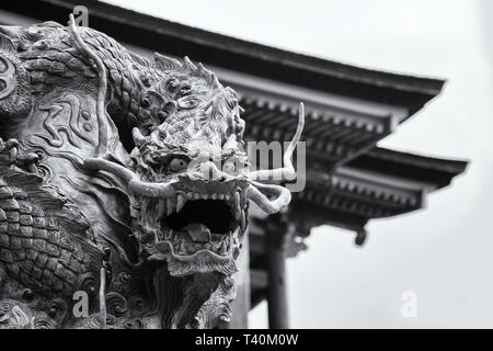 Black and white closeup of an ancient dragon statue outside of the Kiyomizu-dera temple on Mount Otowa. Image taken from a public street. Stock Photo