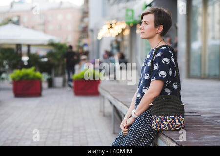 Close up photo of woman bag in hands of fashionable woman. Elegant outfit. Female fashion concept