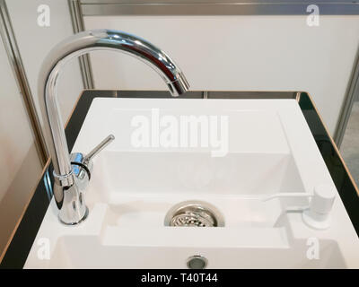 closeup of modern square kitchen sink with two faucets Stock Photo