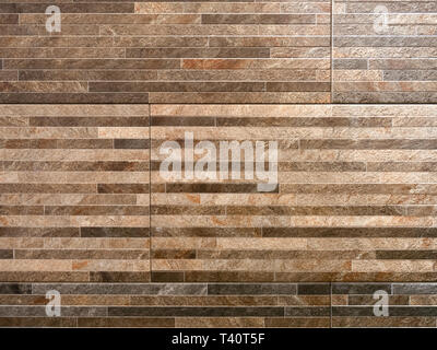 abstract pattern wall made of brown granite stones thin blocks bricks Stock Photo
