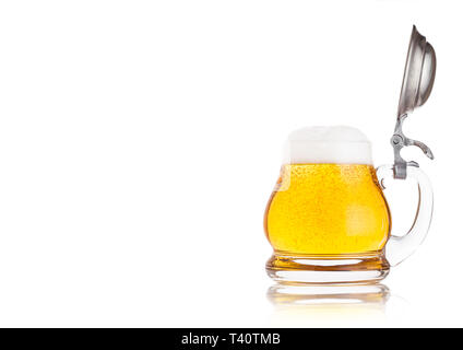 Vintage retro glass of lager ale beer with foam. Glass handle with silver steel top on white background Stock Photo