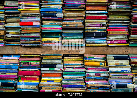 Spines of used books are seen stacked in shelves in a secondhand bookshop in San Salvador, El Salvador. Stock Photo