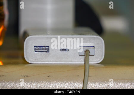 Powerbank for charging gadgets on the table Stock Photo