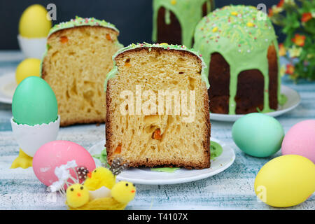 Spring still life of Easter cakes and painted eggs on blue background Stock Photo