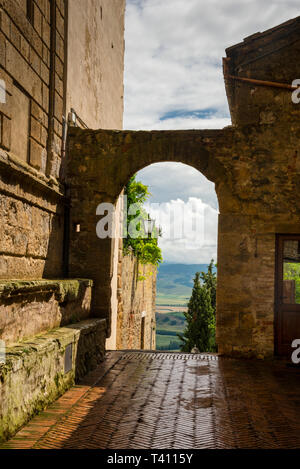 Stone archway and Val d Orcia from the Tuscan Pienza, Italy. Stock Photo