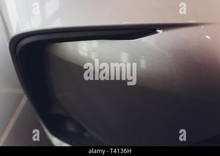 Grid of car with sunflare. Radiator grille. Metal close-up texture background. Chrome grill of big powerful engine macro. Stock Photo