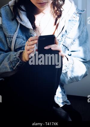 Teenage girl using a mobile phone Stock Photo