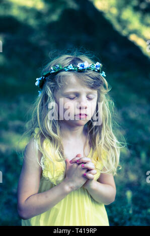 adorable little girl praying vow Stock Photo