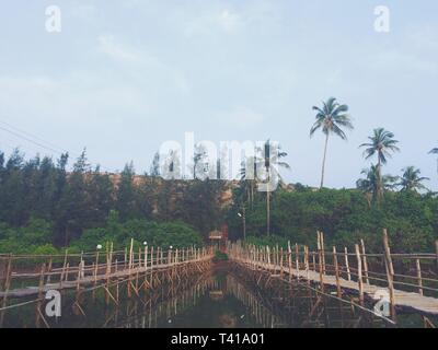 Ruined wooden bridge on the Sweet Lake on Arambol beach in Goa, India. Stock Photo