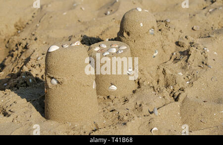 Sand castles on the beach with water shells in scheveningen, the hague, the netherlands Stock Photo