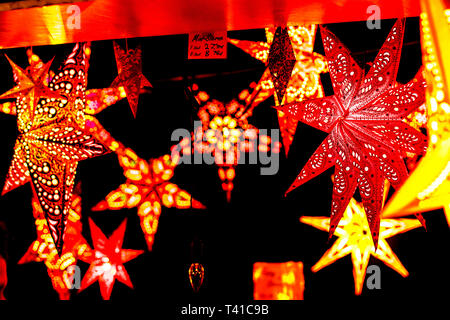 star shaped illuminated Christmas decorations in Berlin night xmas market Stock Photo