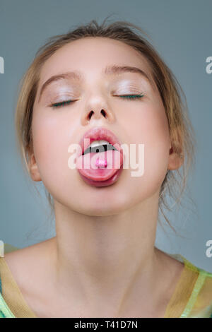 With open mouth. Fair-haired professional unusual model with natural makeup posing with open mouth Stock Photo