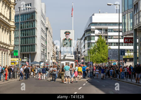 BERLIN, GERMANY - APR 28, 2018: Tourists around the former Allied checkpoint Charlie. Nowadays this site is a tourist attraction. Stock Photo