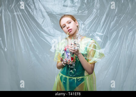 Environmental organization. Fair-haired model working for environmental organization posing with glass and plastic Stock Photo