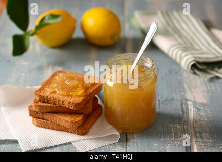 lemon jam in the glass jar with fruit around - closeup Stock Photo