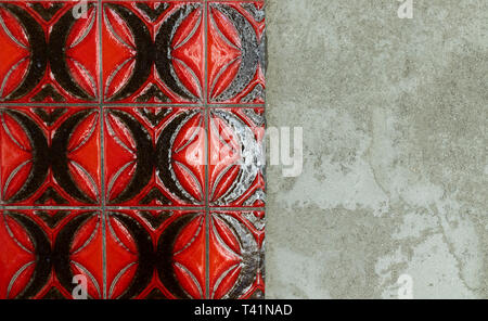 red tiles wall besides cracked and destroyed undersurface Stock Photo