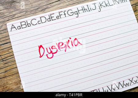 The word Dyslexia is written on a penmanship board in a classroom Stock Photo