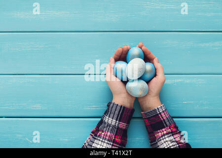 Female hand holding Easter eggs in hands Stock Photo