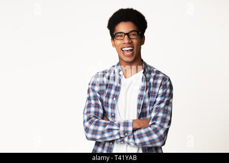 Successful student posing with crossed hands, light background Stock Photo
