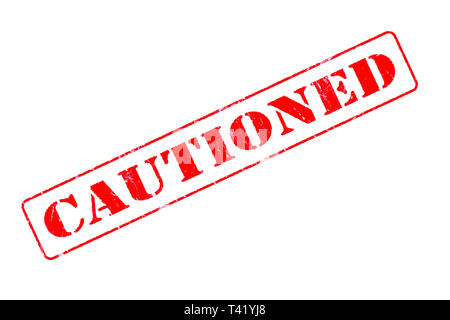 Rubber stamp concept showing a red stamp reading Cautioned Stock Photo
