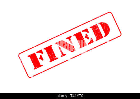 Rubber stamp concept showing a red stamp reading Fined Stock Photo