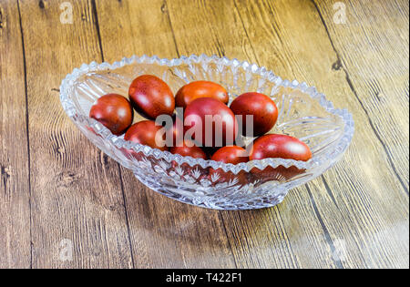 Painted Easter eggs in a crystal vase. Red painted chicken eggs for easter. Stock Photo