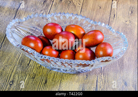 Painted Easter eggs in a crystal vase. Red painted chicken eggs for easter. Stock Photo