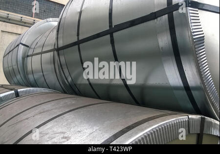 Steel sheets rolled up into rolls. Export Steel. Packing of steel for transportation. Stock Photo