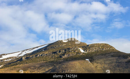 Impressive, rocky, iconic, sunlit Kopren summit on Old mountain and blue sky with white clouds Stock Photo