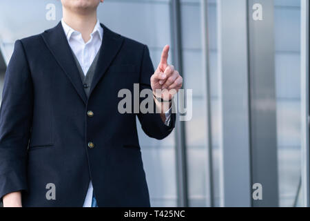 Photo of Business Man pushing on a touch screen interface Stock Photo