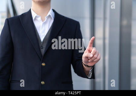 Photo of Business Man pushing on a touch screen interface Stock Photo