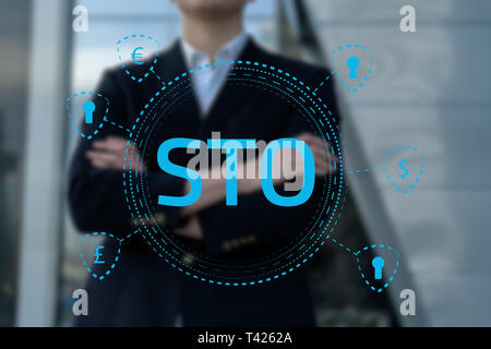 Photo of Security Token Offering STO cryptocurrency and blockchain concept, businessman pressing virtual graphics on virtual screens Stock Photo