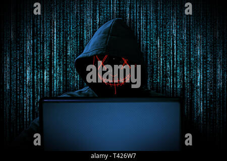 Hacker With Glowing Mask Behind Notebook Laptop In Front Of Isolated ...