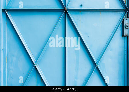 metal industrial shutters - old blue detail aged vintage textured zinc alloy metal roller shutter door. Good for background, backdrop, wallpaper, cons Stock Photo