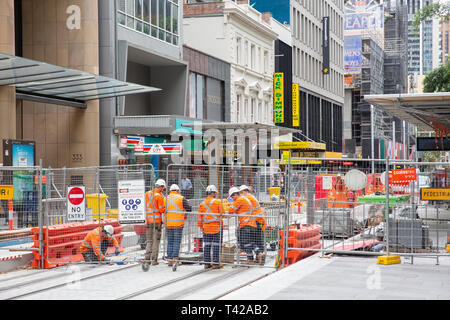 Construction workers in hi viz vests on George street in Sydney city centre working on the CBD light rail construction project,New South Wales,Austral Stock Photo