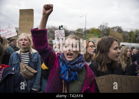 Warsaw, Mazowieckie, Poland. 12th Apr, 2019. A young activist with a painted face is seen shouting during the march.Kids, pupils and students took part in a march organised by Mlodziezowy Strajk Klimatyczny (MSK) which is part of the global movement called ''Youth Strike for Climate''. Protesters demand action from politicians in the matter of global warming, air and earth pollution. Credit: Attila Husejnow/SOPA Images/ZUMA Wire/Alamy Live News Stock Photo