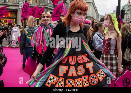 London, UK. 12th Apr, 2019. Extinction Rebellion close Oxford Circus by laying a pink carpet down and performing a fashion show to highlight the fashion industry’s role in climate change. Credit: Claire Doherty/Alamy Live News Stock Photo