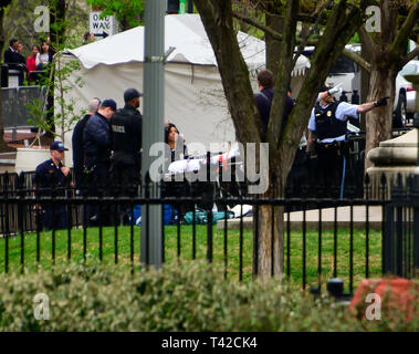 Washington, USA. 12th Apr 2019. An unidentified person is attended to by United States Secret Service and US Park Police during an incident in Lafayette Park, across Pennsylvania Avenue from the White House in Washington, DC on April 12, 2019. Credit: Ron Sachs/CNP /MediaPunch Credit: MediaPunch Inc/Alamy Live News Stock Photo