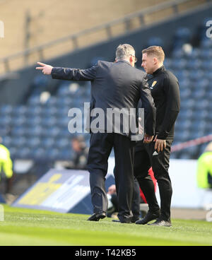 Hampden Park, Glasgow, UK. 13th Apr, 2019. Scottish Cup football, semi final, Heart of Midlothian versus Caledonian Thistle; Heart of Midlothian manager Craig Levein speaks to 4th official John Beaton over a penalty claim Credit: Action Plus Sports/Alamy Live News Stock Photo