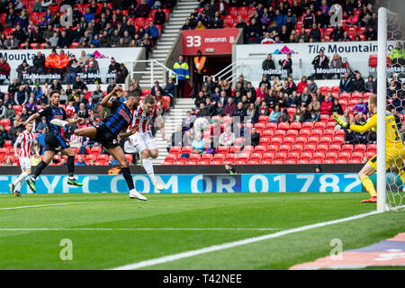 Stoke on Trent , UK. 13th April 2019. STOKE ON TRENT, ENGLAND 13th April     Sam Vokes of Stoke City beats Richard Wood of Rotherham United to the ball to score the opening goal of the game during the Sky Bet Championship match between Stoke City and Rotherham United at the Britannia Stadium, Stoke-on-Trent on   Editorial use only, license required for commercial use. No use in betting, games or a single club/league/player publications. Photograph may only be used for newspaper and/or magazine editorial purposes. May not be used for pub Credit: MI News & Sport /Alamy Live News Stock Photo