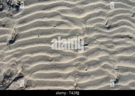 Natural wind sculptured beach sand surface patterns, shapes and textures on the Gulf Coast of Florida, USA. Stock Photo