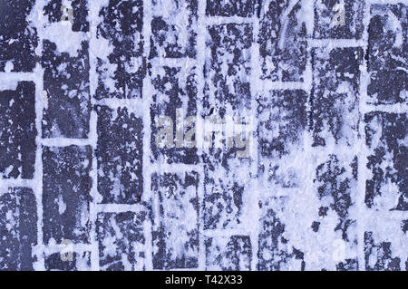 sidewalk cobblestone pavement covered with snow. seasonal, background. Stock Photo