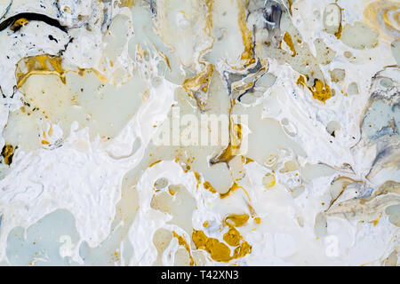 Marble background texture with gold, black, turqoise, blue and white colors, using acrylic pouring medium art technique. Useful as a background. Stock Photo
