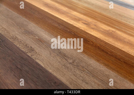 Different soft wood surface as background, wood texture. Wood wall. Close-up of a wide range of laminate in different colors. Stock Photo