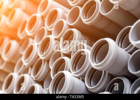 Close up gray plumbing plastic pipes. Background of colorful big plastic pipes used at the building site. Stock Photo