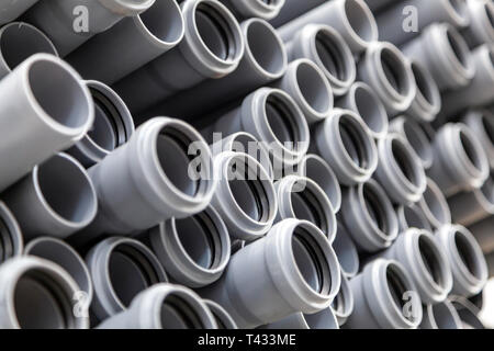 Close up gray plumbing plastic pipes. Background of colorful big plastic pipes used at the building site. Stock Photo