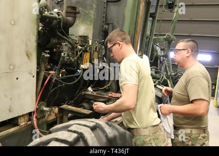 Students in the 91L10 Construction Equipment Maintenance Repairer Course work together to take an engine out of a grader Feb. 20, 2019, during training at Fort McCoy’s Regional Training Site-Maintenance facility at Fort McCoy, Wis. The completion of the course provided the students with certification in the Army’s “91-Lima” career field — construction equipment repairer. According to the Army, construction-equipment repairers are responsible for maintaining trucks, bulldozers, power shovels, and other heavy equipment needed for construction operations. Stock Photo