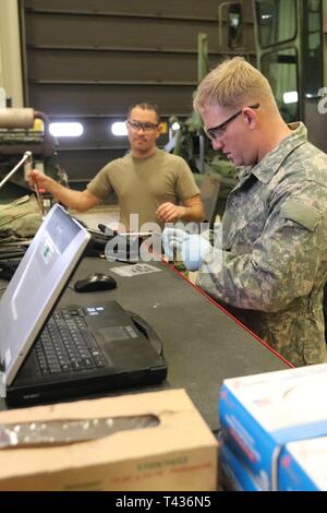 Students in the 91L10 Construction Equipment Maintenance Repairer Course work together to take an engine out of a grader Feb. 20, 2019, during training at Fort McCoy’s Regional Training Site-Maintenance facility at Fort McCoy, Wis. The completion of the course provided the students with certification in the Army’s “91-Lima” career field — construction equipment repairer. According to the Army, construction-equipment repairers are responsible for maintaining trucks, bulldozers, power shovels, and other heavy equipment needed for construction operations. Stock Photo